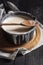 Milk in a rustic saucepan on a black table