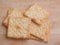 Milk square crackers on wooden background