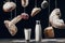 Milk on table and bread with flour hanging on strings isolated on black.