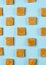 Milk toffee pattern, caramelized candy on blue background, top view