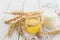 Milk, wheat spikelets and honey. Wooden table