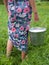 Milkmaid holding bucket with milk