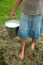 Milkmaid holding bucket with milk