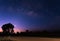 The milky way above dirt road before sunrise