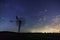 The milky way core rises above a windmill in central Germany