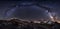 Milky Way galaxy and mountain peaks panorama.