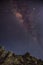 Milky Way Galaxy rises above big rocks pile