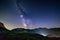 The Milky way galaxy and stars over the Italian French Alps. Night sky on majestic snowcapped mountains and glaciers. Meteor