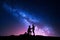 Milky Way. Night landscape with silhouettes of a couple