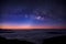 Milky way on night sky over foggy mountain