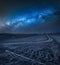 Milky way over Harrows on a brown field in Tuscany