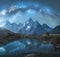 Milky Way over snowy mountains and lake at night. Landscape