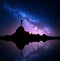 Milky Way and silhouette of a standing woman on mountain