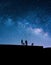 Milky Way and silhouettes of people.