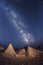 Milky way sky on beach with big rocks