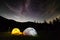 Milky way sky stars over mountain high tent camp
