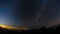 Milky way and star time-lapse moving across the sky with silhouetted on the hight mountain in forest, Thailand.