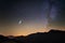 Milky Way and starry sky from high up on the Alps. Real Christmas comet in the sky. Majestic high mountain range with glacier and