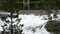 Milky white massive long waterfall down slippery valley rocks and stones in summer