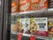 Mill Creek, WA USA - circa May 2022: Angled view of a variety of frozen pizzas for sale inside the freezer section of a Town and