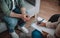 Millennial african american woman psychologist listens to european patient, takes notes in clinic office interior