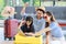 Millennial Asian lovely happy family father mother and young little girl daughter helping packing stuff in trolley luggage