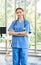 Millennial Asian young beautiful professional successful female internship nurse in blue clinical uniform with stethoscope