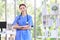 Millennial Asian young beautiful professional successful female internship nurse in blue clinical uniform with stethoscope