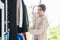 Millennial Asian young professional male dressmaker designer seamstress standing working checking adjusting choosing clothes