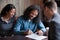 Millennial black spouses signing formal paper in presence of lawyer