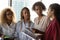 Millennial black women employees listen to leader at office hall