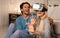 Millennial Couple Experiencing Virtual Reality At Home