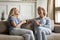 Millennial daughter drinking tea with older mom during pleasant conversation