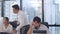 Millennial group of young Asia businessman and businesswoman in small modern urban office. Japanese male boss supervisor teaching