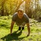 Millennial muscular sportsman with painful face expression squeezed last push-ups approach