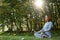 Millennial slim ginger woman doing yoga outdoor on nature in city in autumn sunny day on sunrise