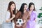 Millennial three Asian beautiful cheerful excited female girlfriends in casual outfit standing smiling holding football exciting