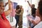 Millennial woman and family welcoming young African American  male soldier home, embracing in doorway, close up