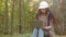 Millennial woman young experienced specialist forestry engineer environmentalist technician in hardhat checking trees