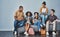 Millennials aka social media experts. Studio shot of young people sitting on a sofa and using wireless technology