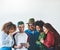 Millennials, the tech experts. Studio shot of a group of young people using a digital tablet together.