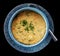 Millet cereal in stoneware bowl shot from above, isolated