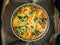 Millet quiche with smoked salmon, spinach and black olives in cooking pan, top view