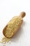 Millet seed grain in wooden scoop on white background