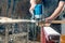 Milling wood in the joinery using manual mechanical cutters. Flying sawdust in the air. Copy space