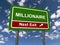 Millionaire next exit road sign