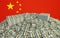 Millions of Dollars - Pile of new 100 Dollar Bills in front of the Chinese flag