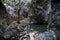 Millomeris waterfall pool, tree roots and pebble rocks, near Platres, Cyprus