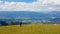 Millstaettersee - A man in black hiking through a lush pasture with the panoramic view on Alpine valley in Austria.