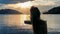 Millstaettersee - A woman in a blue dress flips her long, brown hair by the shore of Millstaettersee lake. The sun is setting